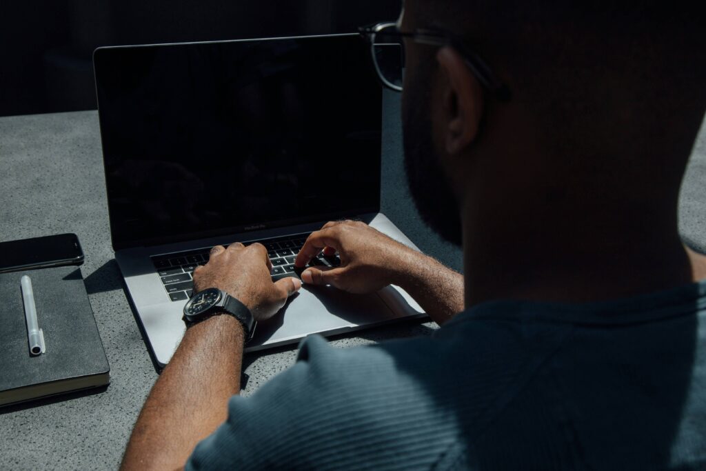 man typing | online continuing education credits for counselors | online continuing education credits for therapists | therapist ceu | Missouri | New Mexico | Mississippi A man wearing a watch typing on a laptop, working on CEUs. Discover how our online continuing education for counselors can help you reach your goals. Learn more here!