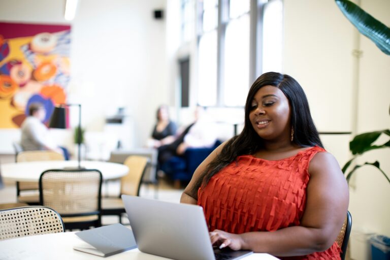 A woman wearing a red blouse smiling while typing notes on her computer. Continuing education for counselors can help you stay up with the ever changing healthcare system. Find out more by reading our blog!
