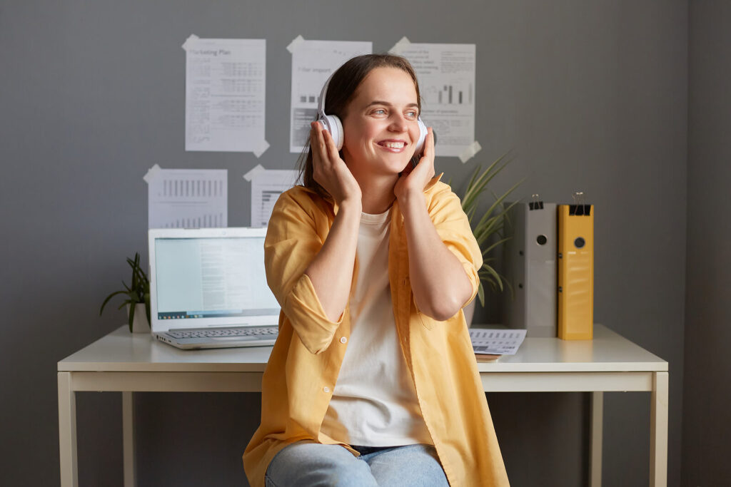A therapist putting on white headphones & smiling. Our online continuing education can help counselors, social workers & therapists. Learn more by reading our blog!