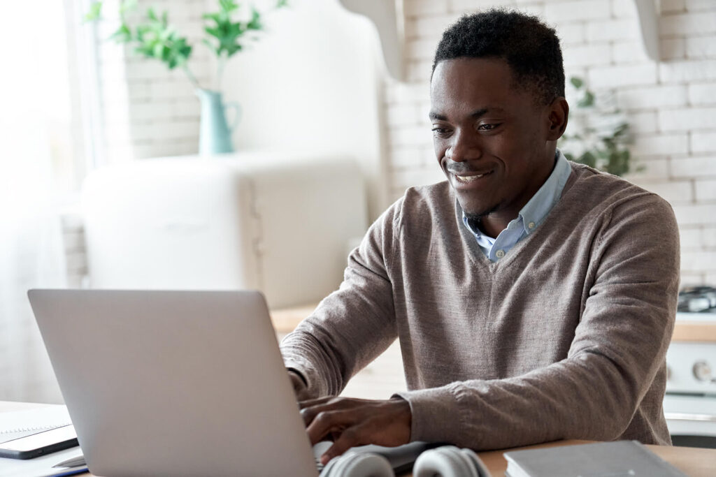 A businessman sitting down smiling while typing on his laptop. Did you know that online continuing education doesn't have to be a snooze fest? Read our blog here on why professional development is important. 