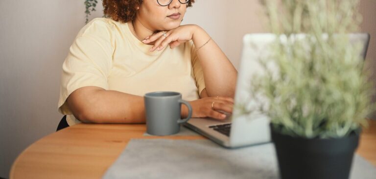 A woman typing on her computer while sitting next to a coffee mug. Did you know our therapist continuing education can be done online?? Read our blog here for more information on obtaining you CE credits!