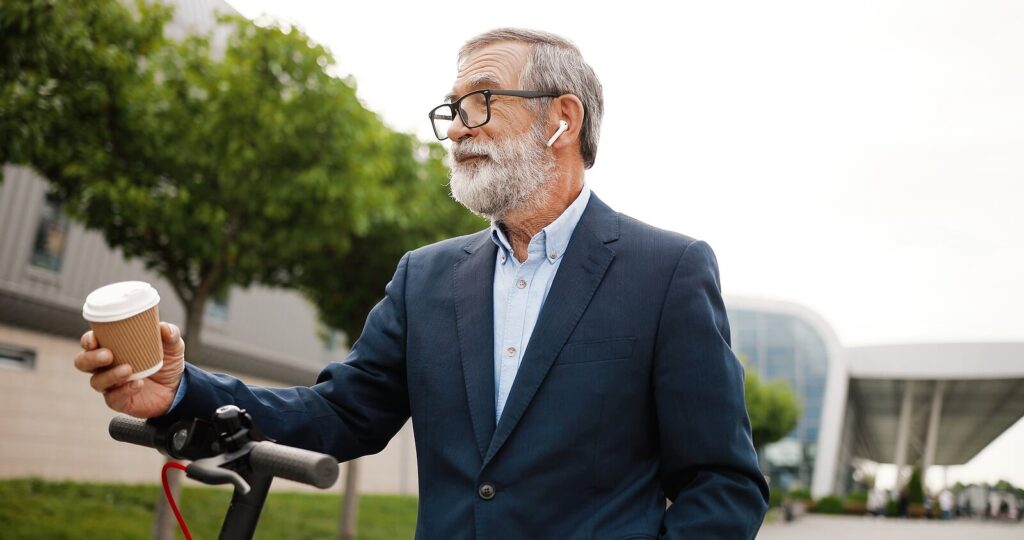 An older man wearing airpods & carrying a coffee cup. Representing how our therapist continuing education can be done from the comfort of your own home, on the go or at your office! Read our blog for more information about CE requirements. 